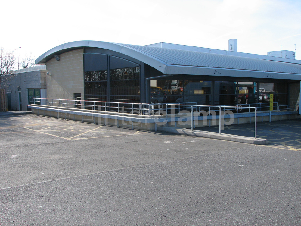 galvanised key clamp guardrail constructed on top of a concrete wall at a service station